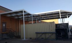 metal carport over a dumpster